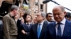 French President Emmanuel Macron gestures as he visits Irpin with Italian Prime Minister Mario Draghi and German Chancellor Olaf Scholz on June 16, 2022. 