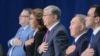 KAZAKHSTAN -- Former Kazakh president Nursultan Nazarbaev, Kazakh interim President Qasym-Zhomart Toqaev and other attendees listen to the national anthem as they attend a congress of the ruling Nur Otan party in Nur-Sultan, April 23, 201