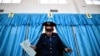 Kzakhstan -- A Kazakh policeman votes during parliamentary elections in the Kazakh city of Baikonur, also known as Russian-leased Baikonur cosmodrom, March 20, 2016