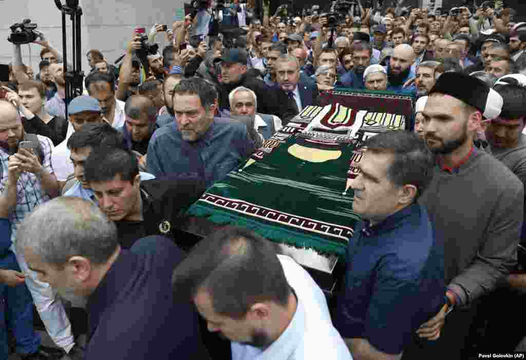 RUSSIA -- Relatives and friends of journalist Orkhan Dzhemal, who was killed in the Central African Republic, carry his coffin during funeral ceremony in Moscow, August 7, 2018