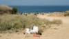 CRIMEA - - Vacationers throw garbage and park cars near the beach in Nemetskaya Balka - Sevastopol, Ukraine, 19July2021